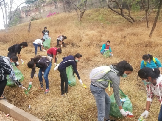 Students of St Mira's College clearing plastic and garbage on Parvati Hill during a green trek