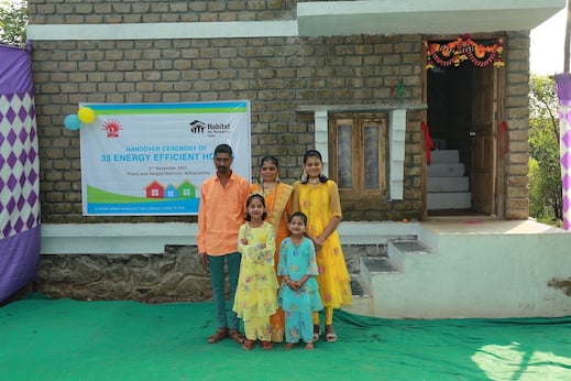 Bharti Kochare with her family outside their newly built energy efficient home in Vangani, Thane district